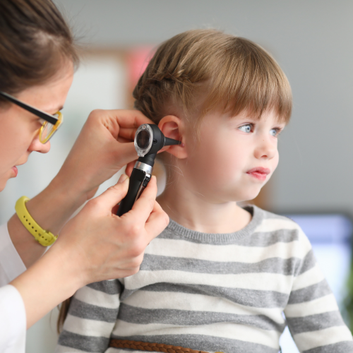 Doctor interacting with a young child patient in a friendly manner